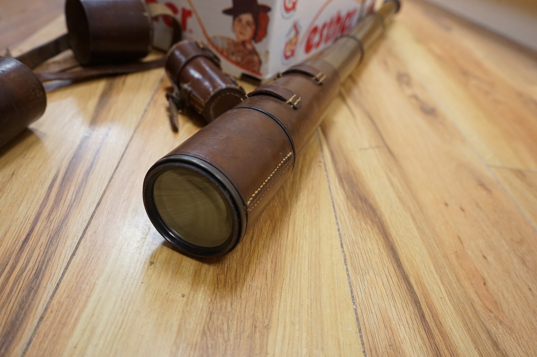 A Sykes-Fairburn Fighting Knife by Wilkinson sword in its leather scabbard, together with a 1942 Mk.III military compass by T.G.Co.Ltd. in a webbing pouch dated 1940, together with another compass, a telescope in a leath